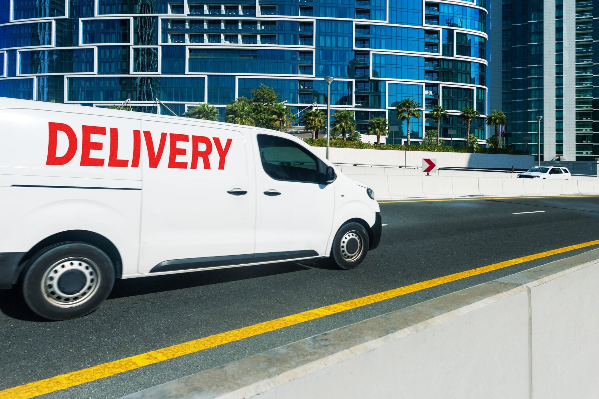A delivery van travelling through the city streets at Dubai, UAE.